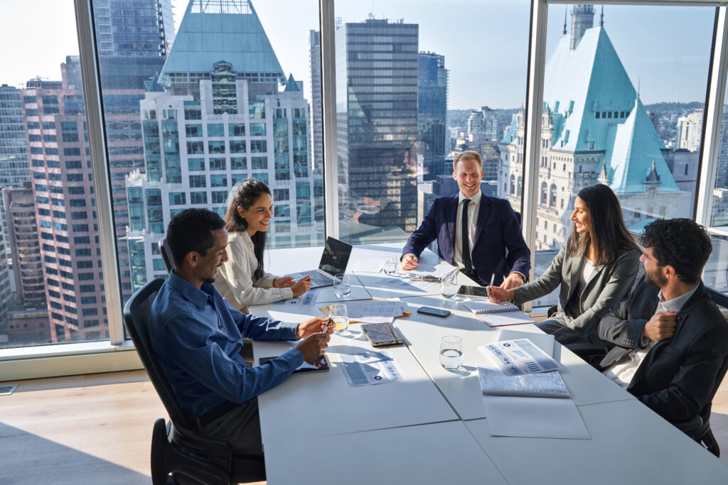 Executive team meeting in a modern boardroom reviewing financial reports and discussing private equity investment strategies against a city skyline backdrop.