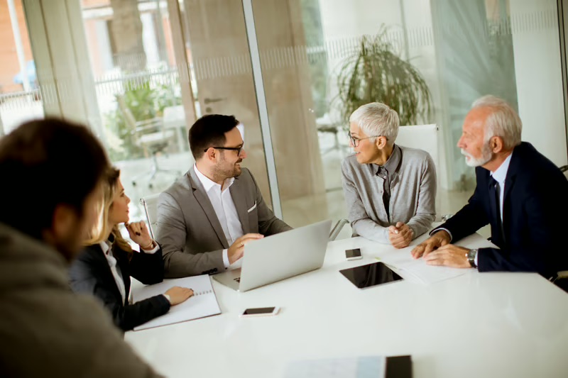 Family wealth advisors meeting with multiple generations to discuss generational wealth, governance, and legacy planning